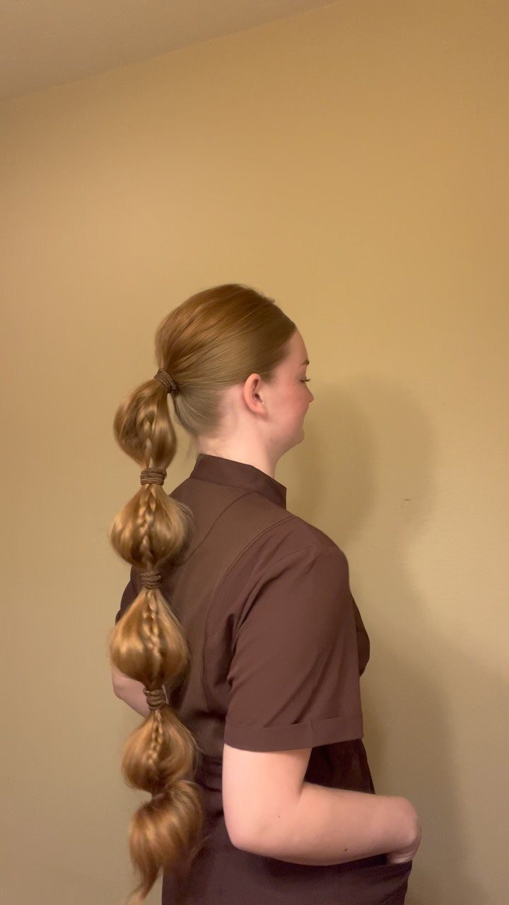 Long blonde bubble ponytail with rounded sections tied down the length