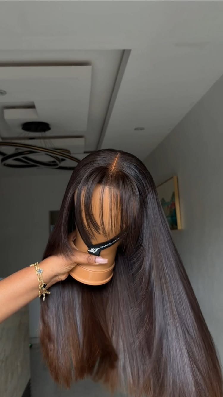 Long, glossy straight brown hair displayed on a mannequin head