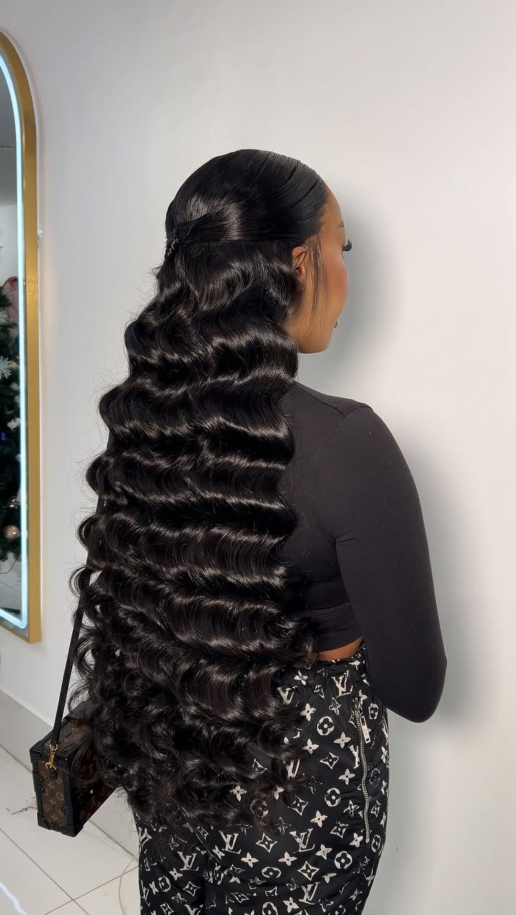 Woman with very long black hair styled in glossy, brushed-out waves