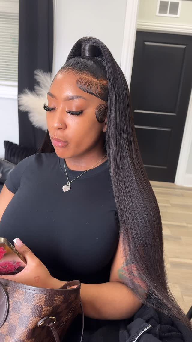 Woman showing a sleek high ponytail with very long straight black hair