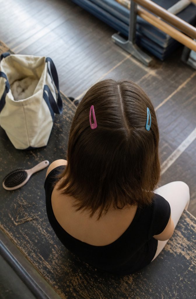 Colorful flat snap clips holding hair at the sides