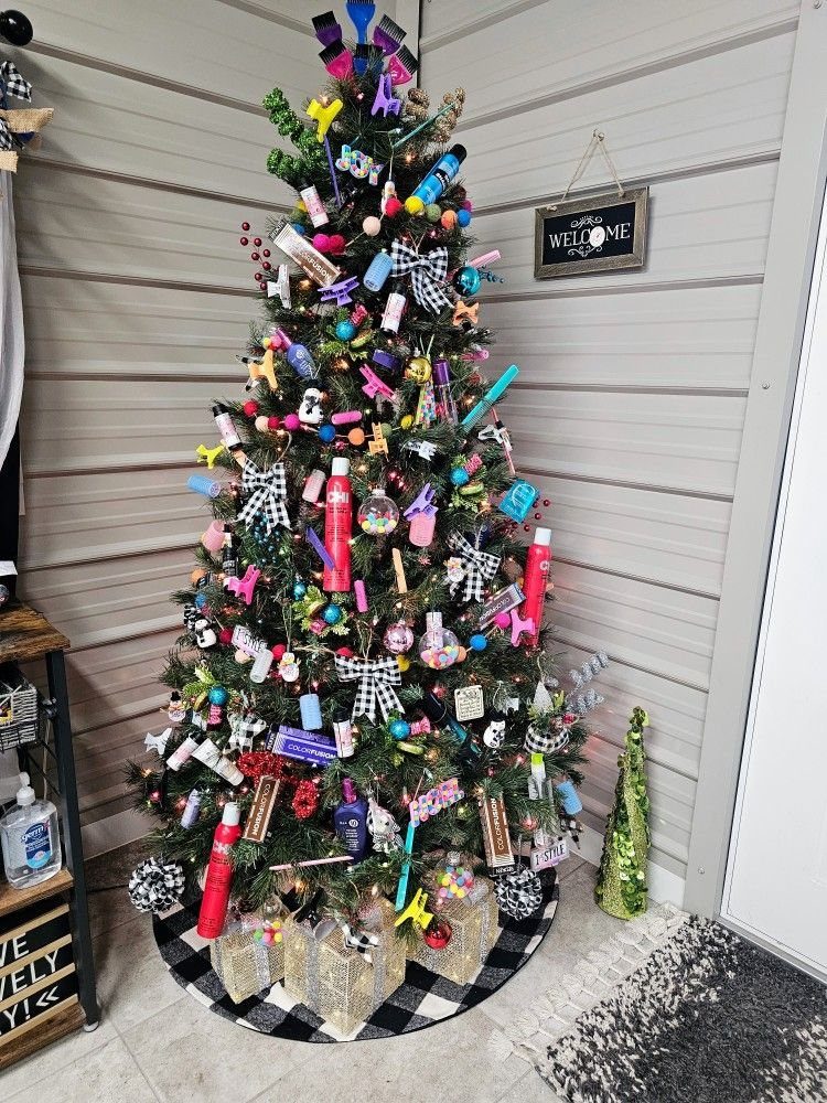 Evergreen Christmas tree decorated with salon products, colorful clips, and ribbons