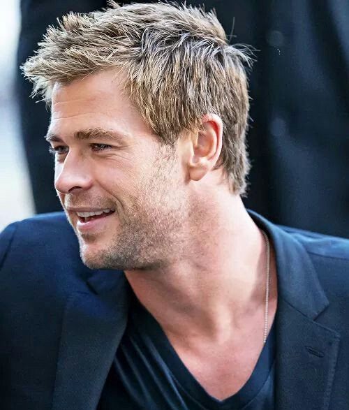 Man with short blond hair styled into textured, upward-pointing spikes