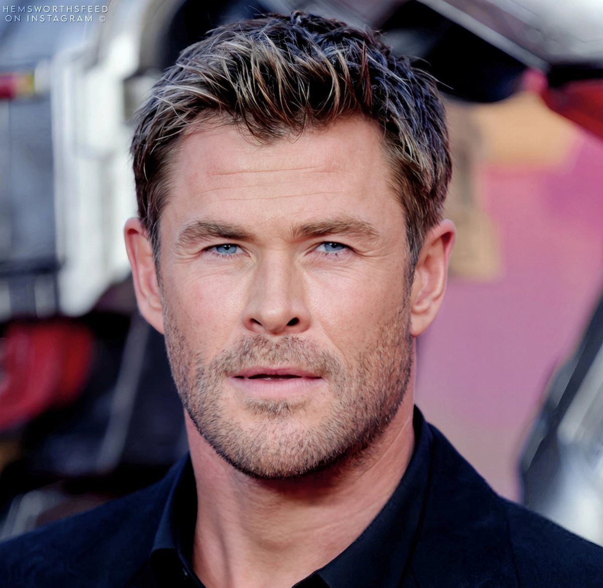 Chris Hemsworth with short, textured brown hair swept upward