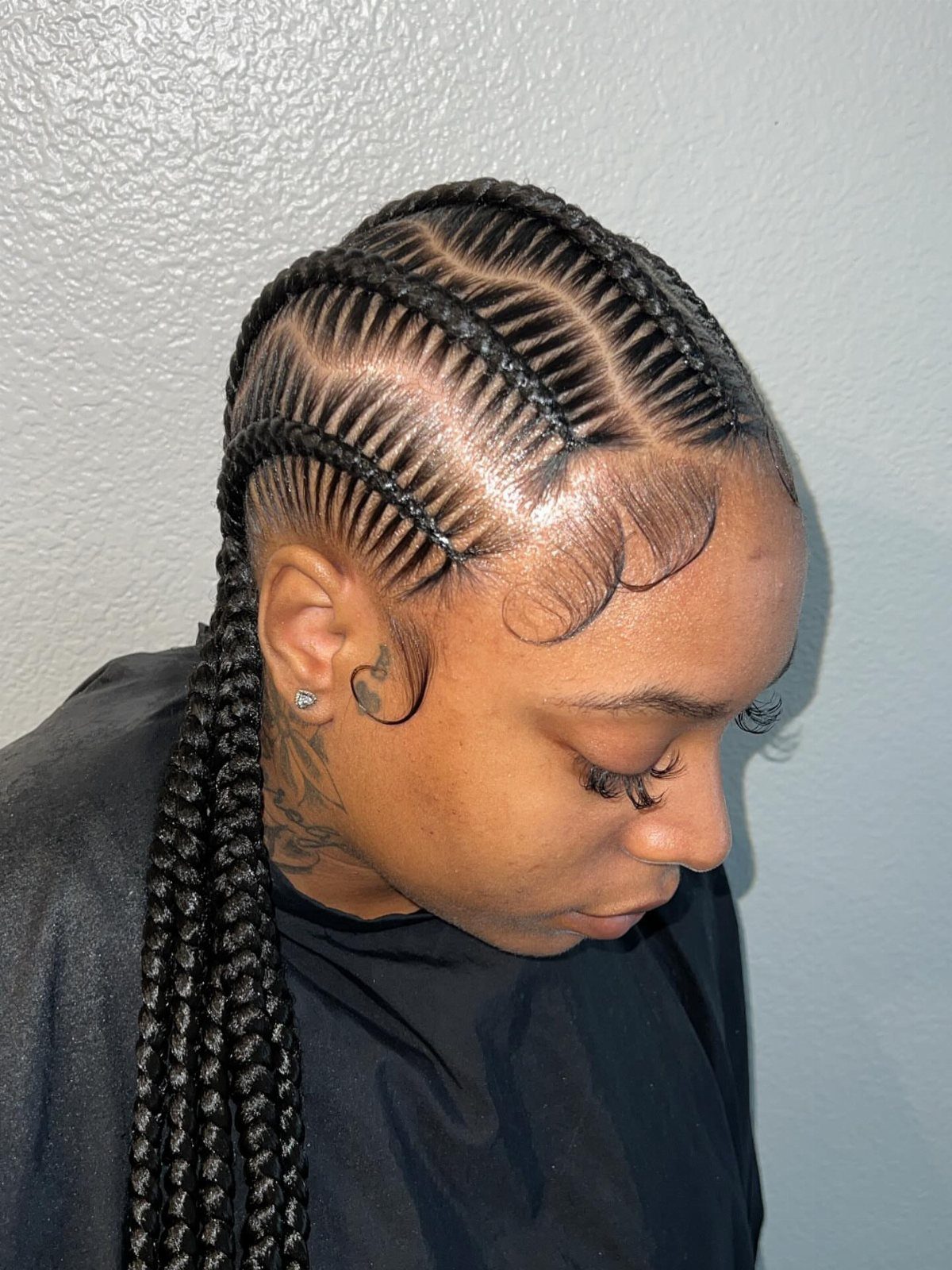 Cornrows transition into long black box braids on a person's head