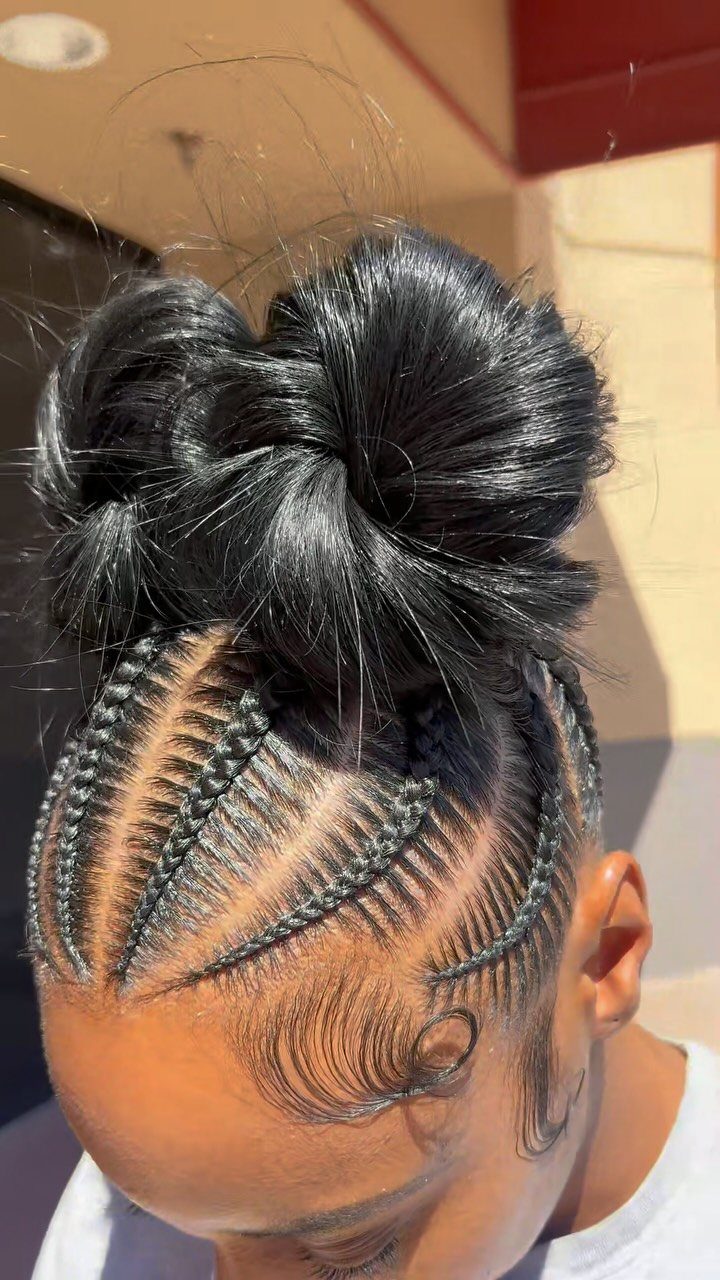 Black cornrows gathered into a large bun with styled edges
