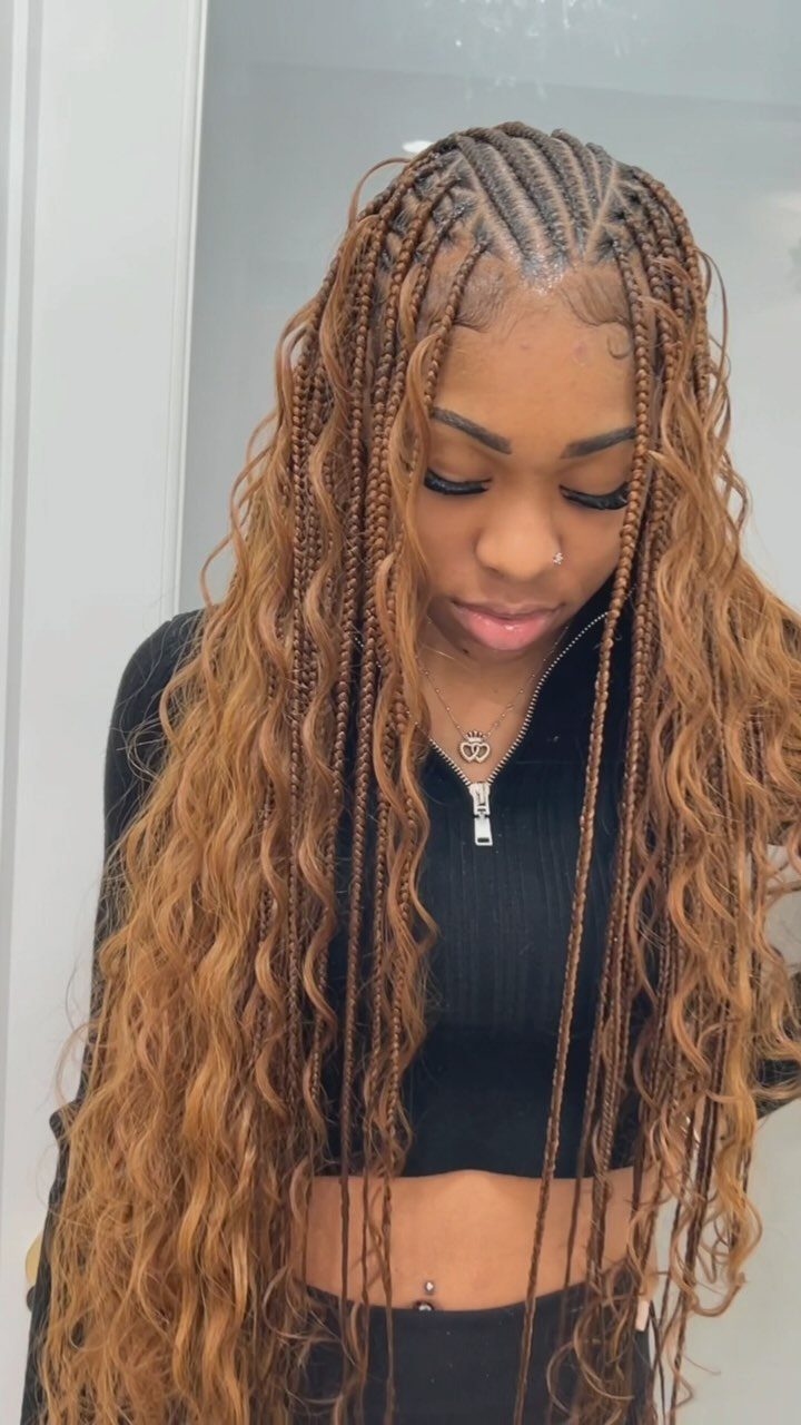 Woman wearing long narrow scalp braids with loose wavy brown hair
