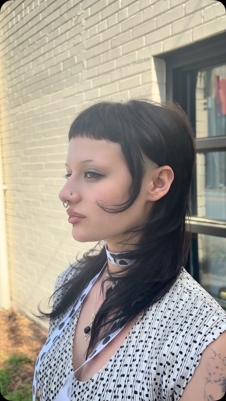 Person with dark hair, very short blunt bangs, and long straight sides