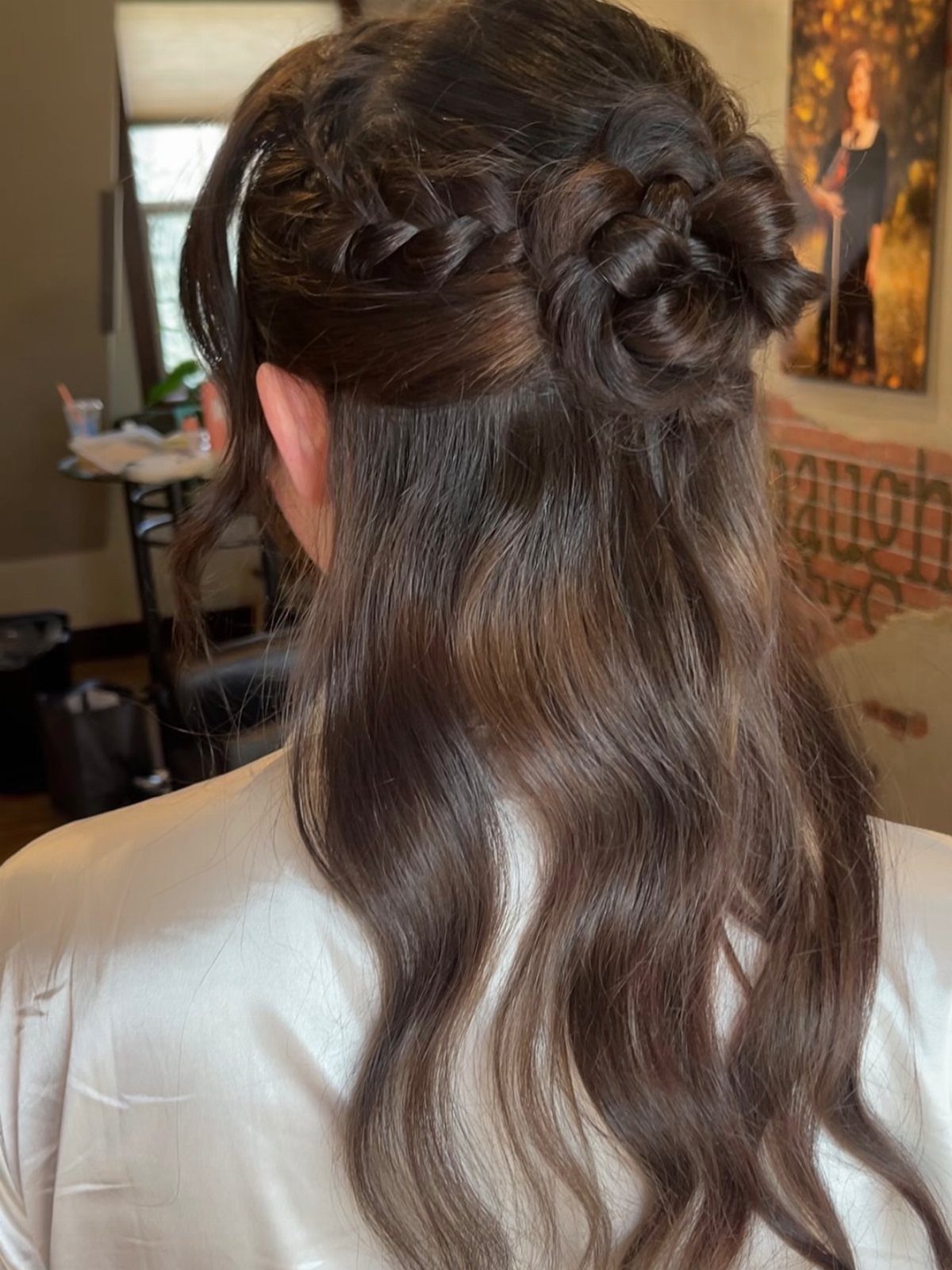 Braided half-up bun with tiny side braids and long loose waves