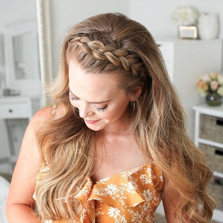 Woman showcasing easy braided hairstyle with long wavy blonde hair