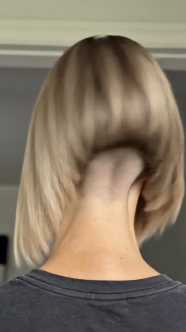 Angled blonde bob shows longer sides tapering to a short nape