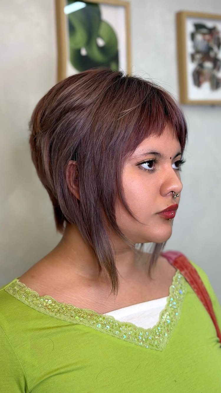 Woman displaying an asymmetrical brown bob with side-swept bangs