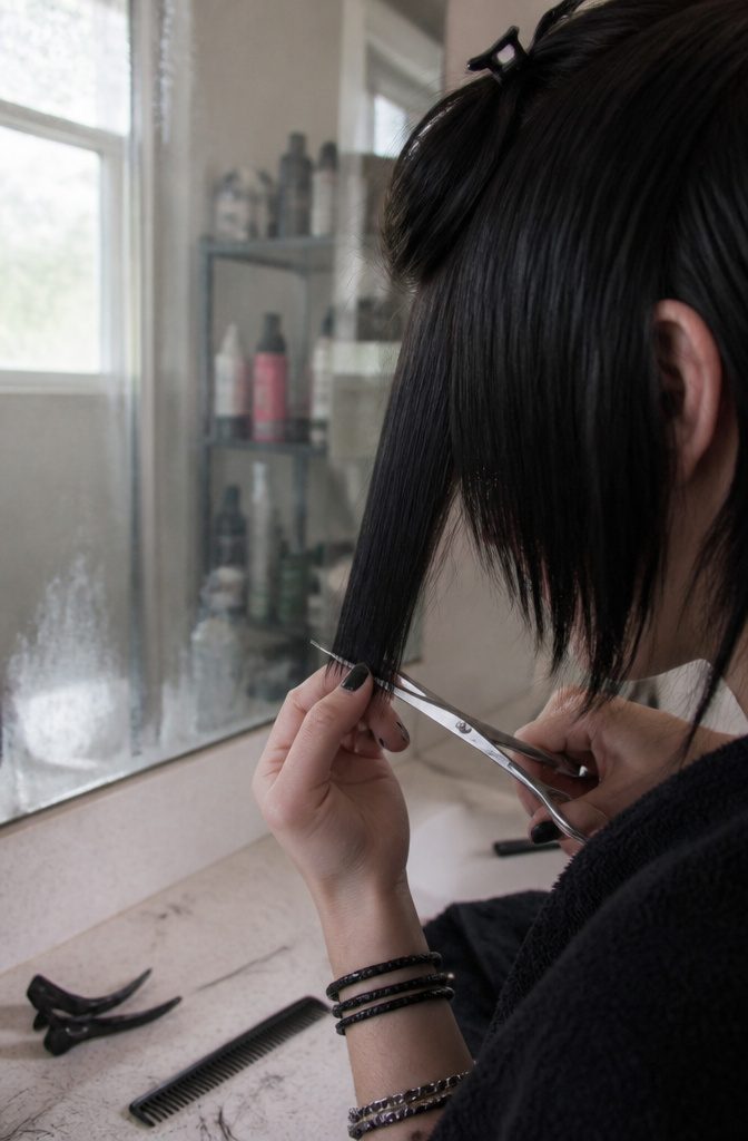 Long side-swept bangs fall across the face toward the chin