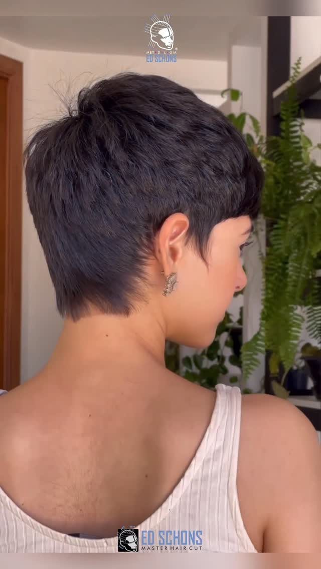 Short dark pixie haircut with tapered nape, shown from behind in profile