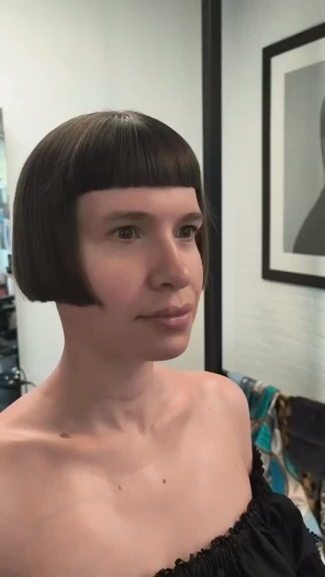 Person models a straight dark blunt bob with short bangs