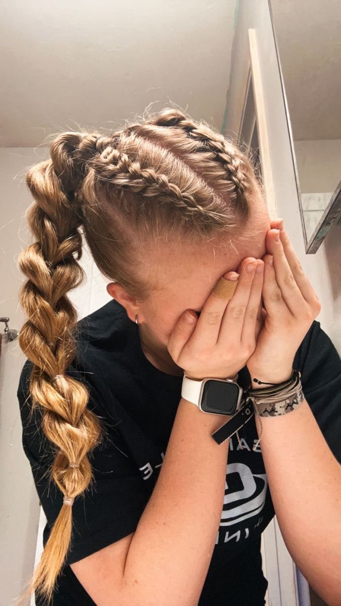 Person showing a French braid with small side braids along the crown