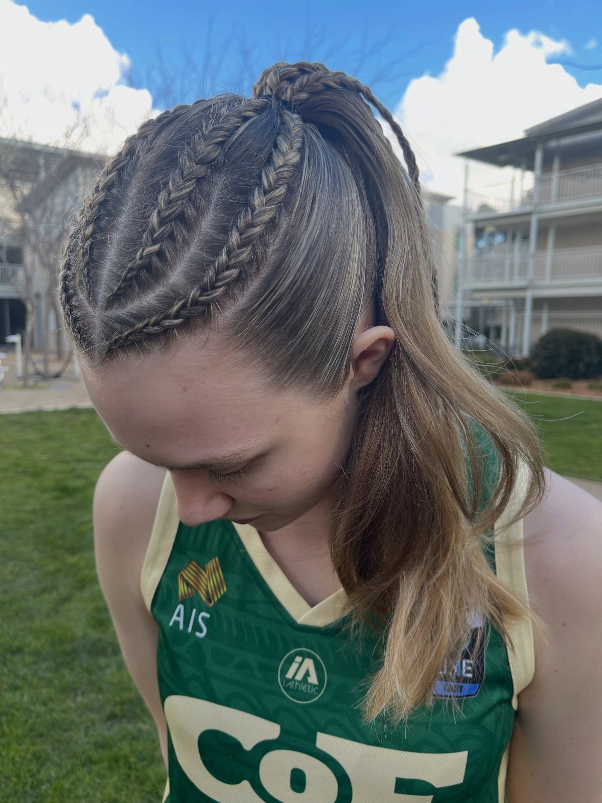 Volleyball player wearing two French braids joined into a high ponytail