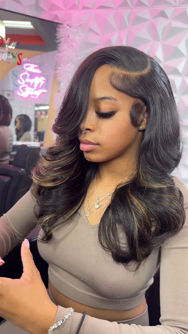 Woman showing glossy curled hair with a pronounced deep side part