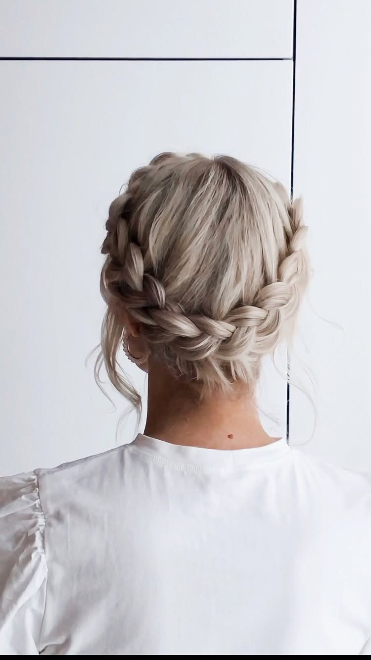 Blonde crown braid wrapped around the back of a person's head