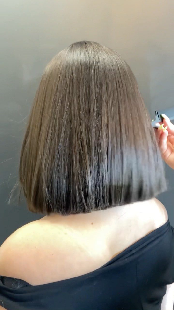 Blunt ash-brown bob shown from behind with smooth, straight ends