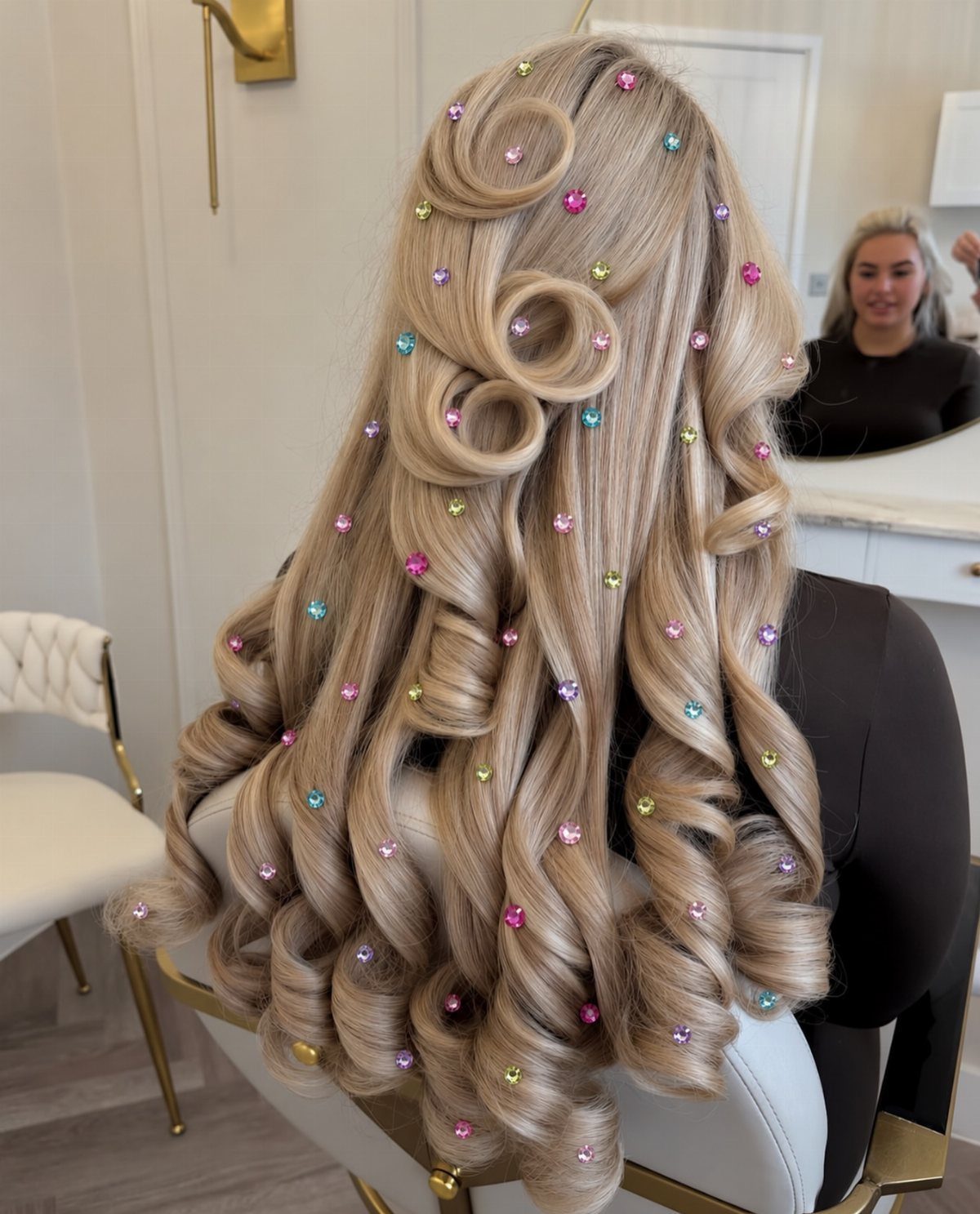 Long blonde curls decorated with colorful clips in a bright salon