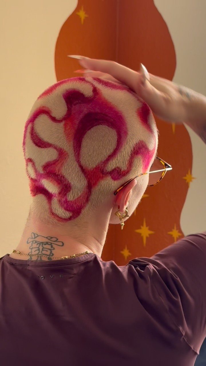 Short bleached hair with vivid magenta swirls and shaved patterns