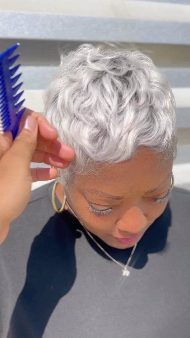 Short silver-white curls styled with a blue wide-tooth comb in a salon