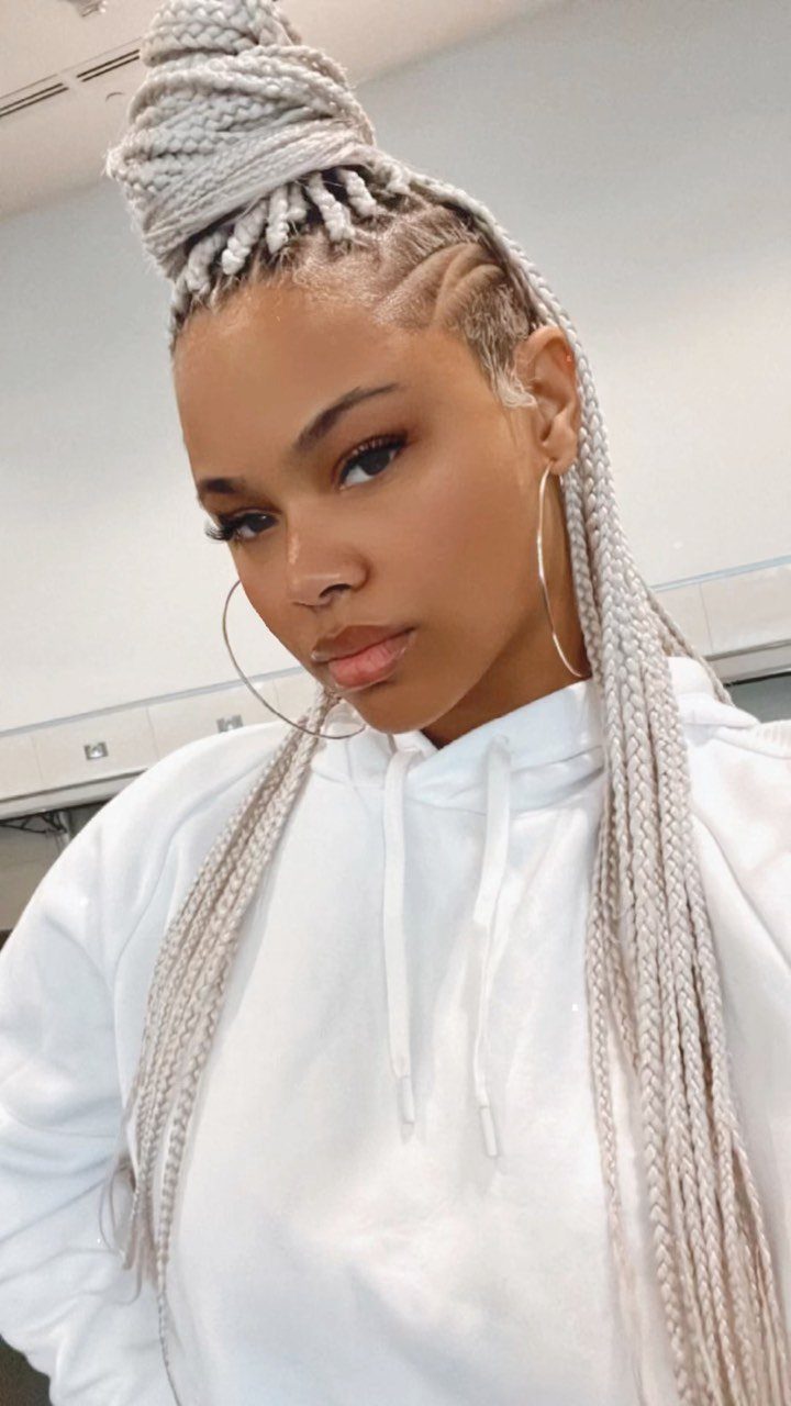 Woman with pale-blonde braids and geometric shaved side design