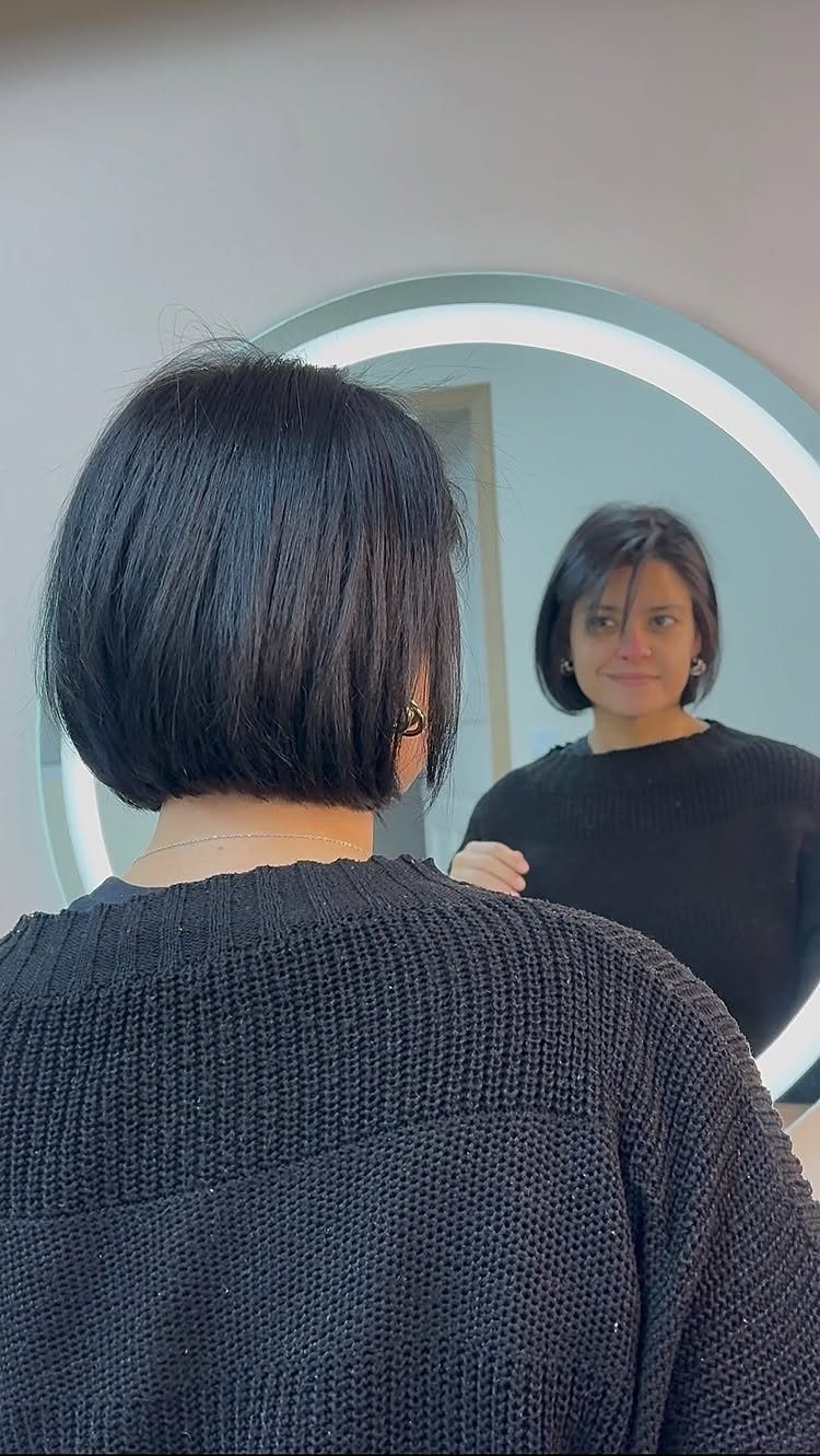 Short dark bob shown from the back and in a round mirror