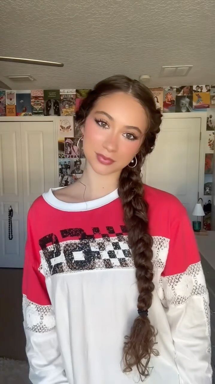 Young woman with a long, loose brown side braid over her shoulder