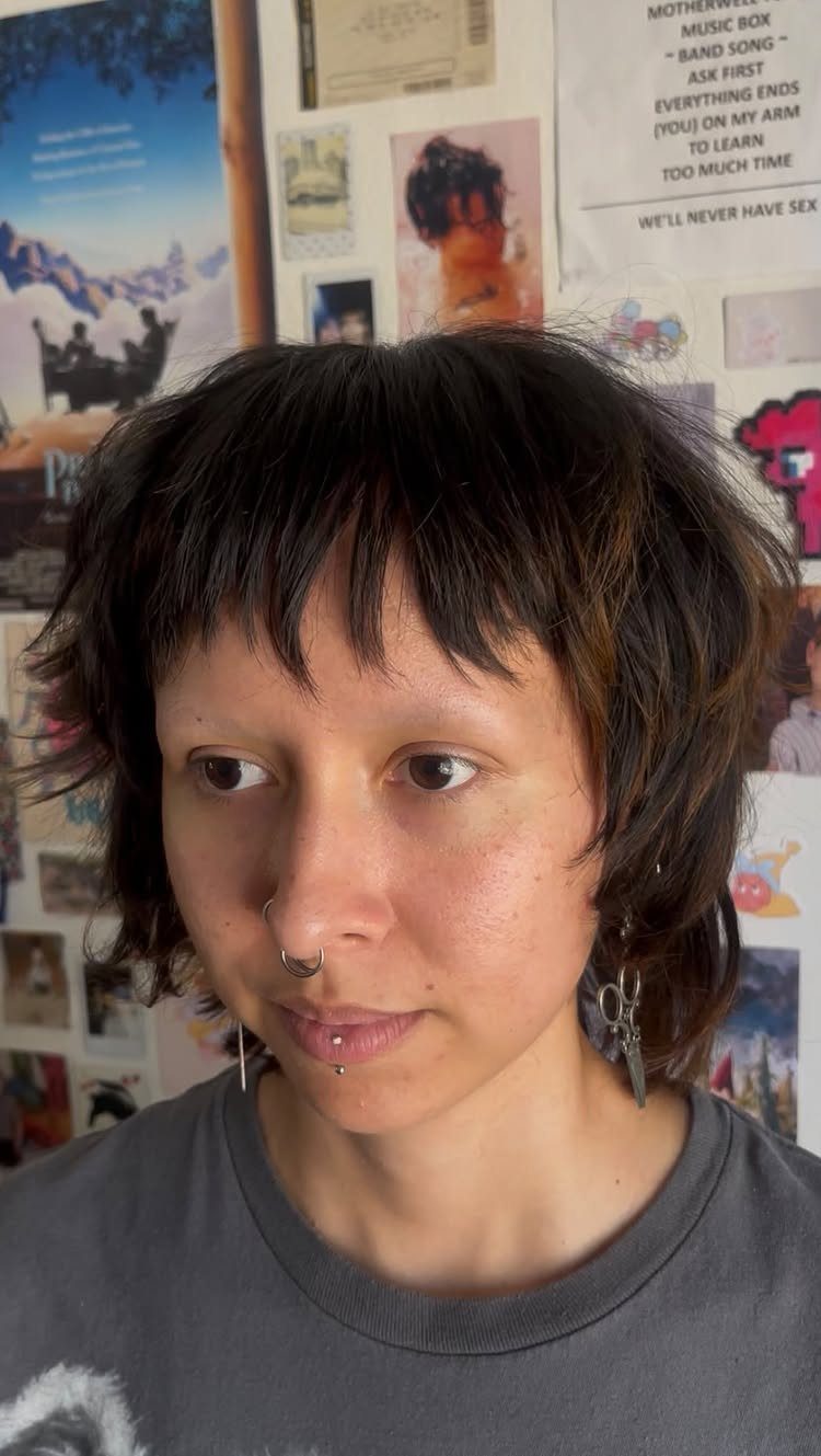 Young person showing a short, choppy shag haircut with wispy bangs