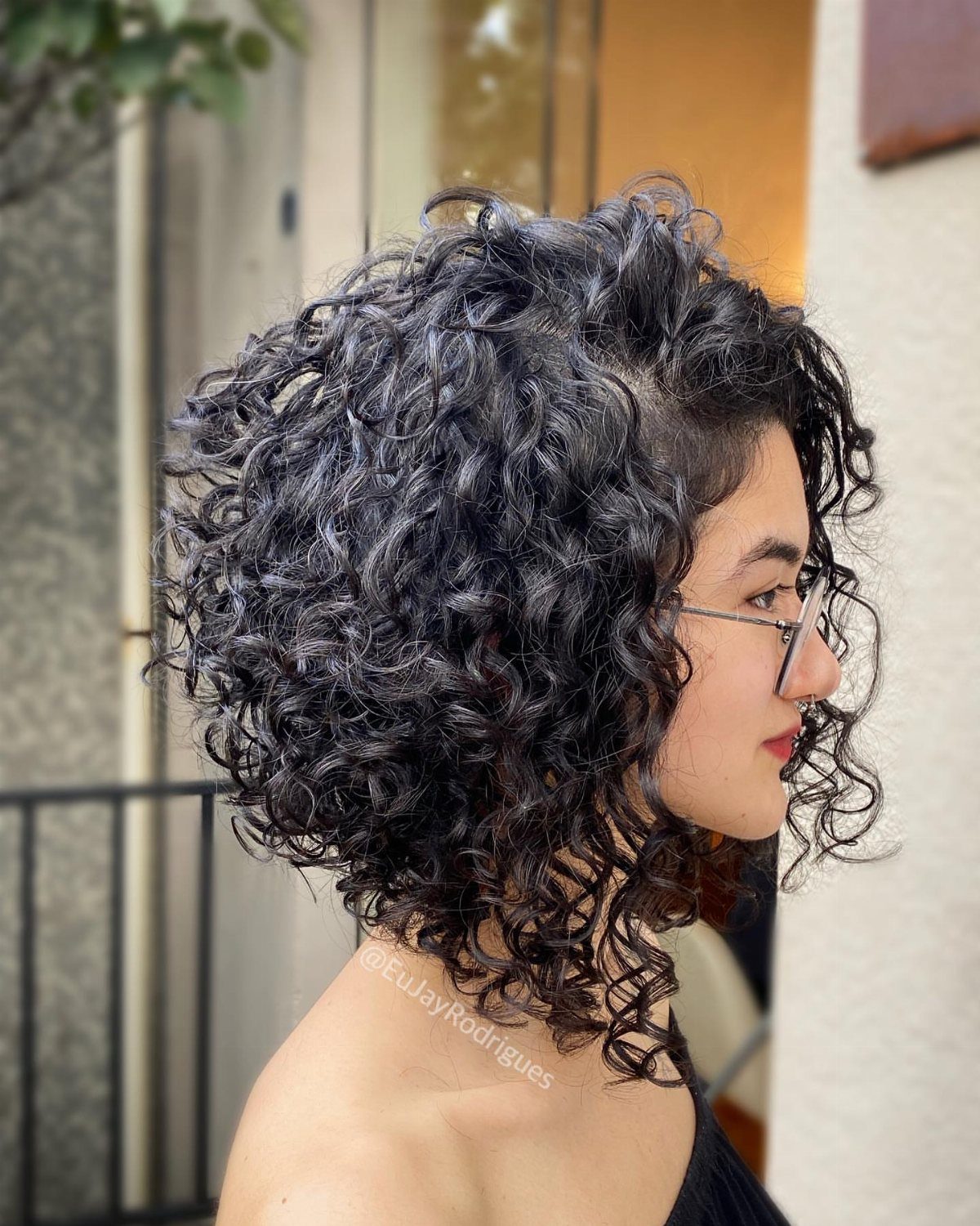 Woman with voluminous natural curls falling around her shoulders