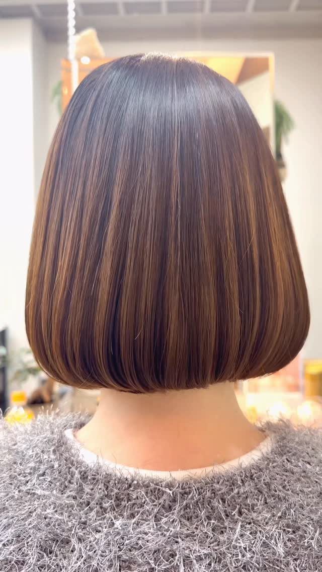 Glossy dark brown bob with rounded ends at the nape