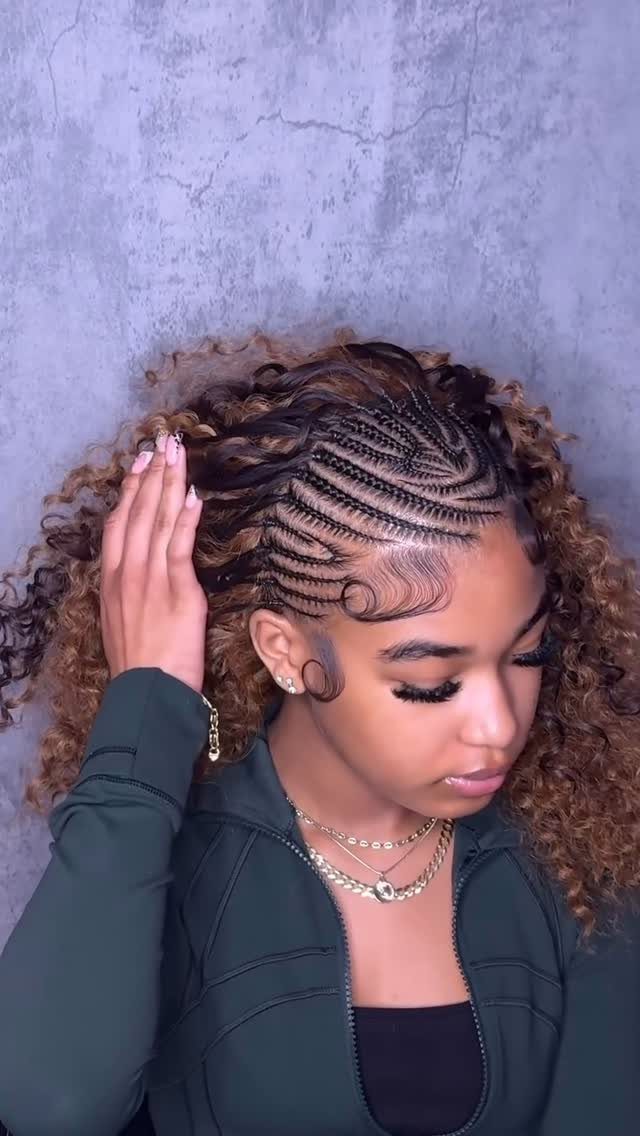 Woman showing curly half-up hair with intricate cornrow detailing