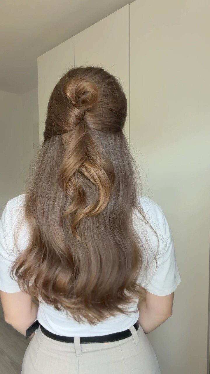 Twisted bun with long loose waves cascading down the back