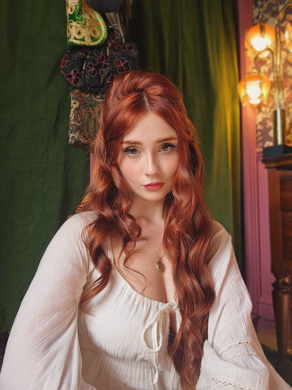 Red-haired woman with a bouffant and long face-framing curls