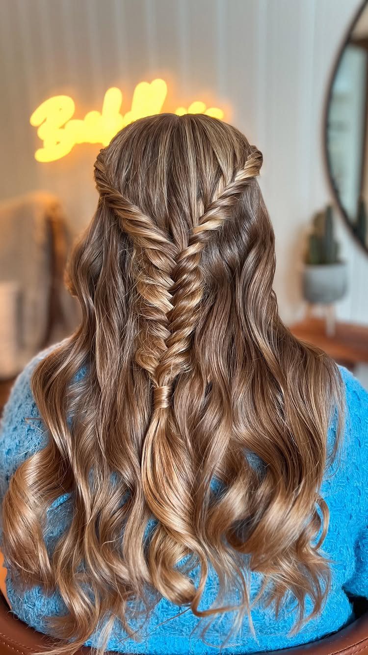 Long wavy brown hair twisted together at the back