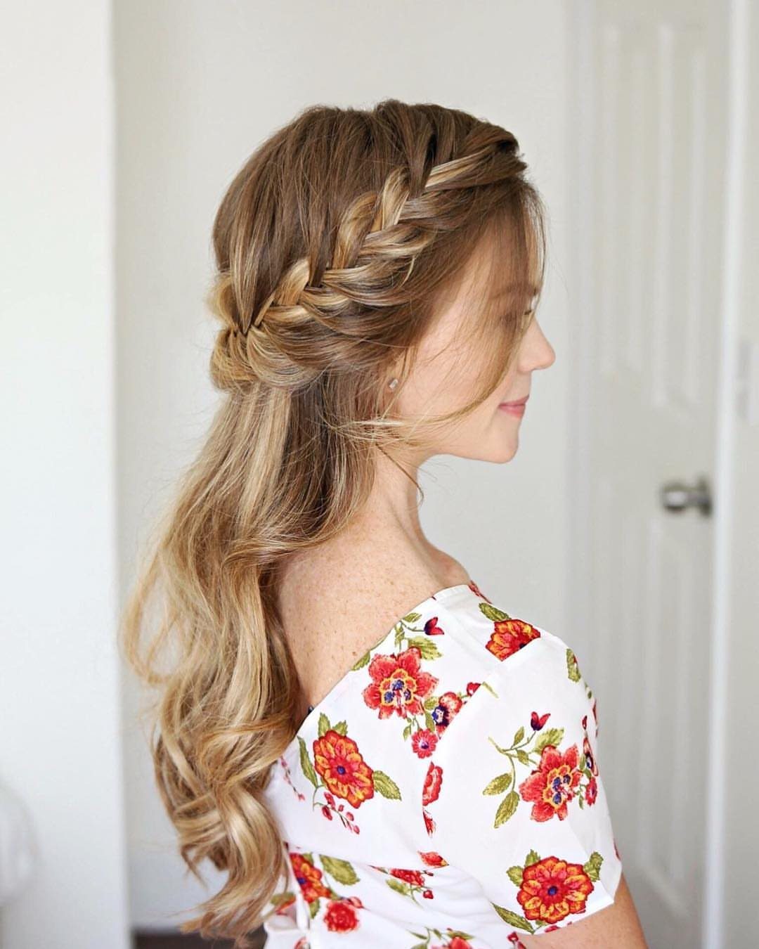 Woman wearing a loose fishtail braid with long curls left down