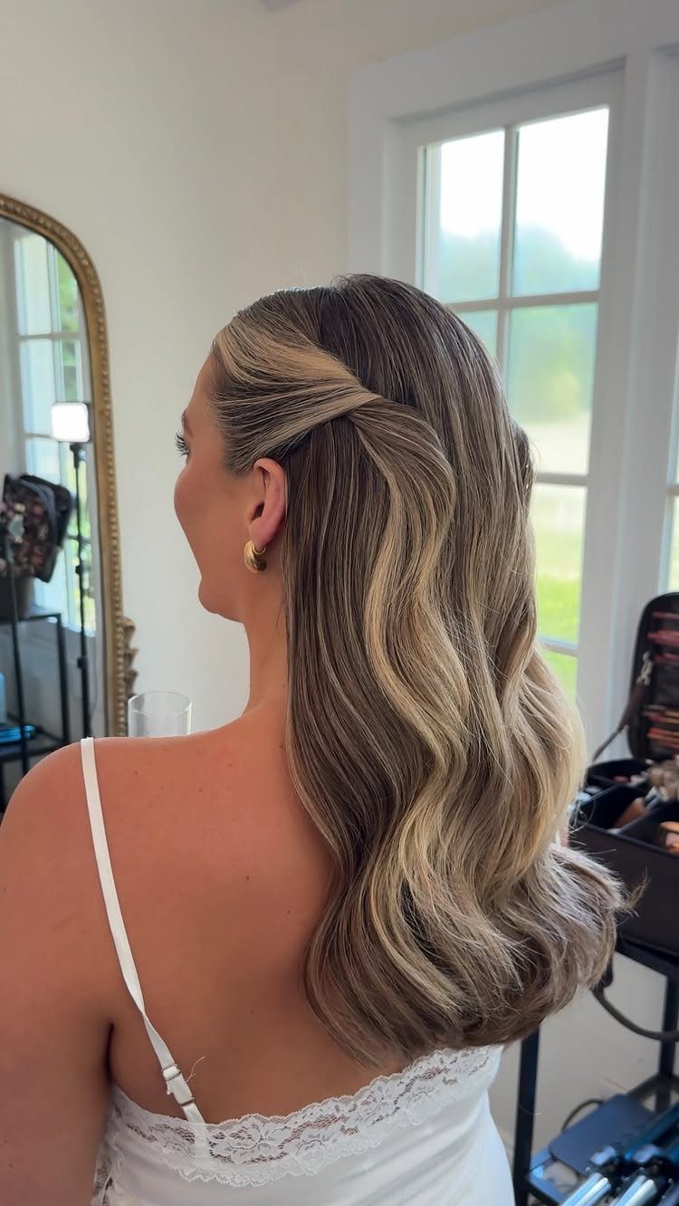 Long wavy hair with a side section swept and pinned back