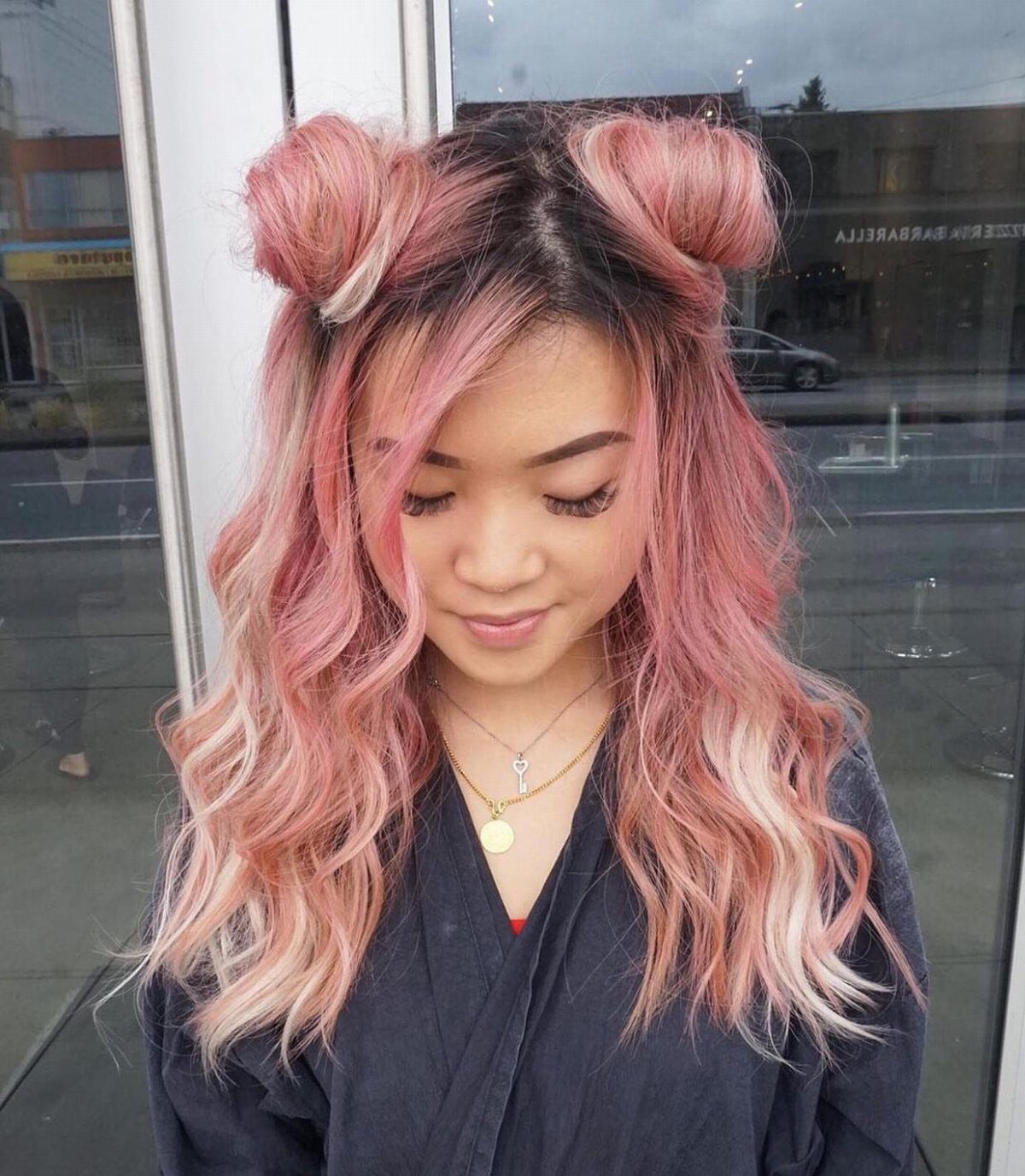 Woman with long pink waves and two small space buns above her temples