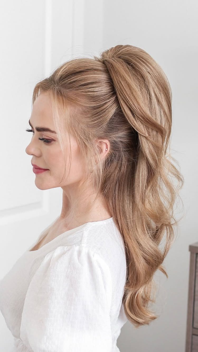 Blonde woman wearing a voluminous half-up ponytail with a wrapped tie