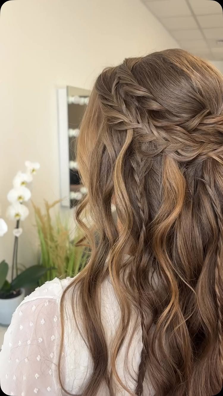 Long wavy hair with a loose braided half-up style cascading down