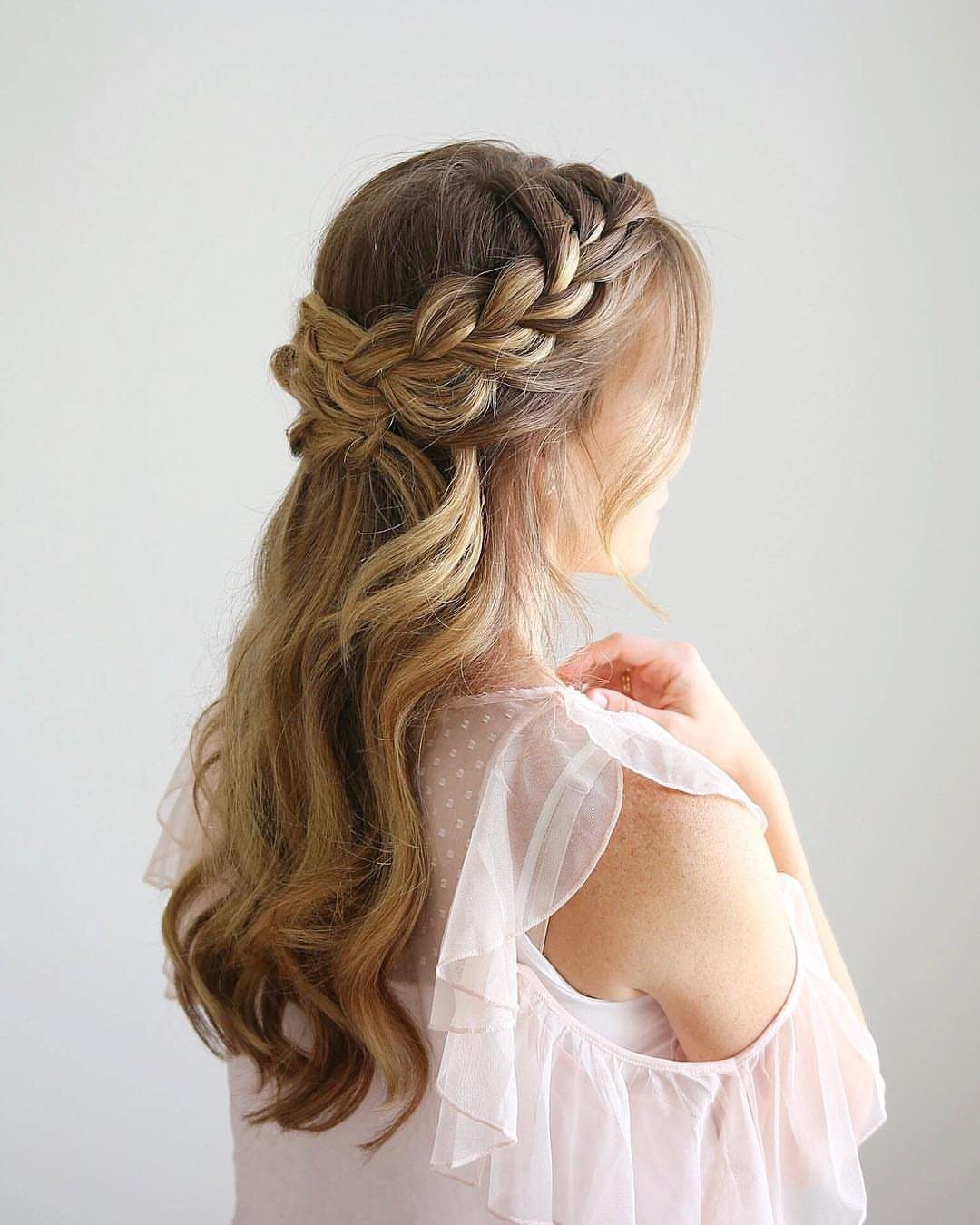 Long wavy hair styled in a braided crown half-up look