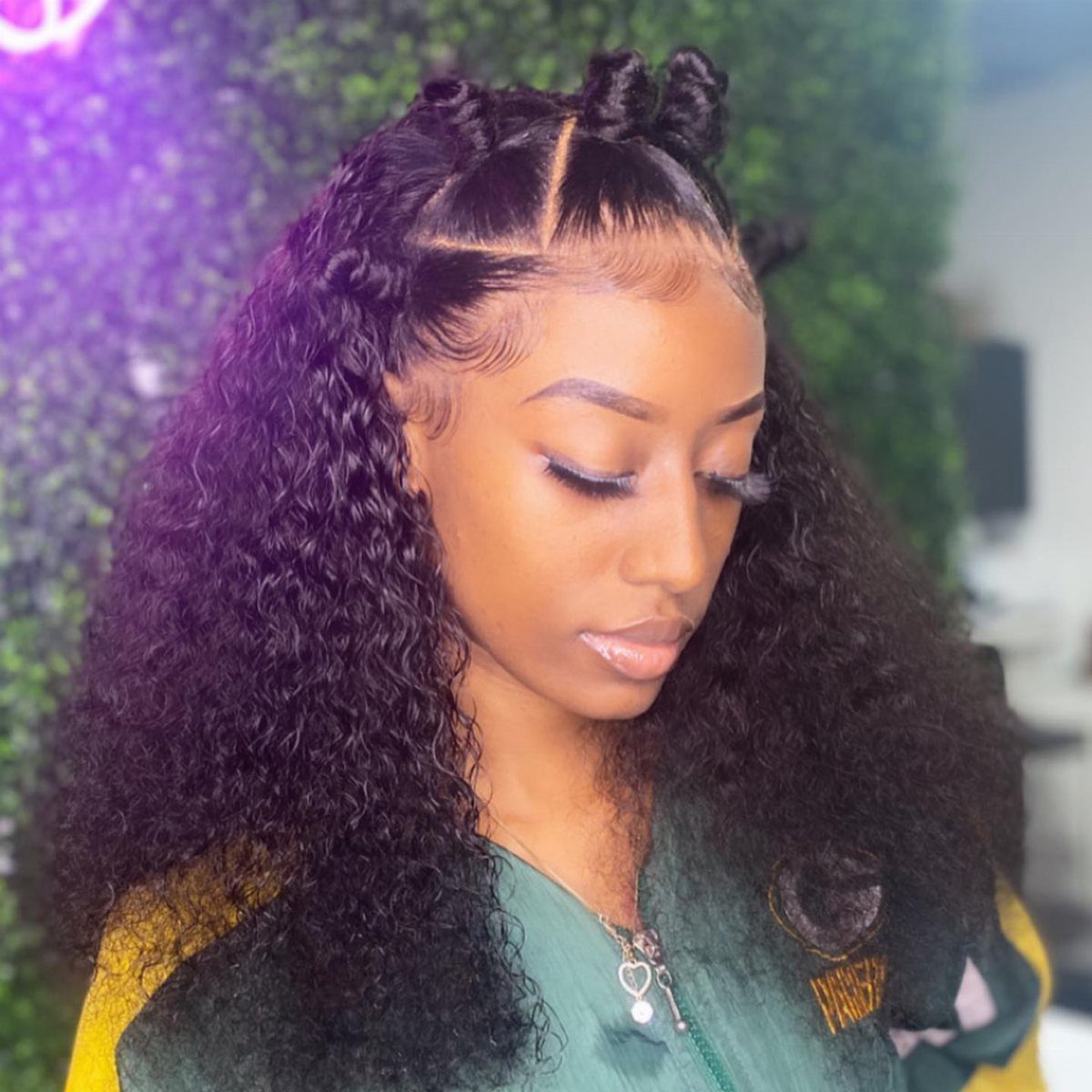 Woman wearing two small half-up hair knots with long curls left down