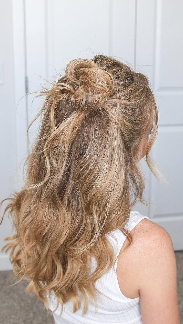 Blonde wavy hair styled half up in a looped knot