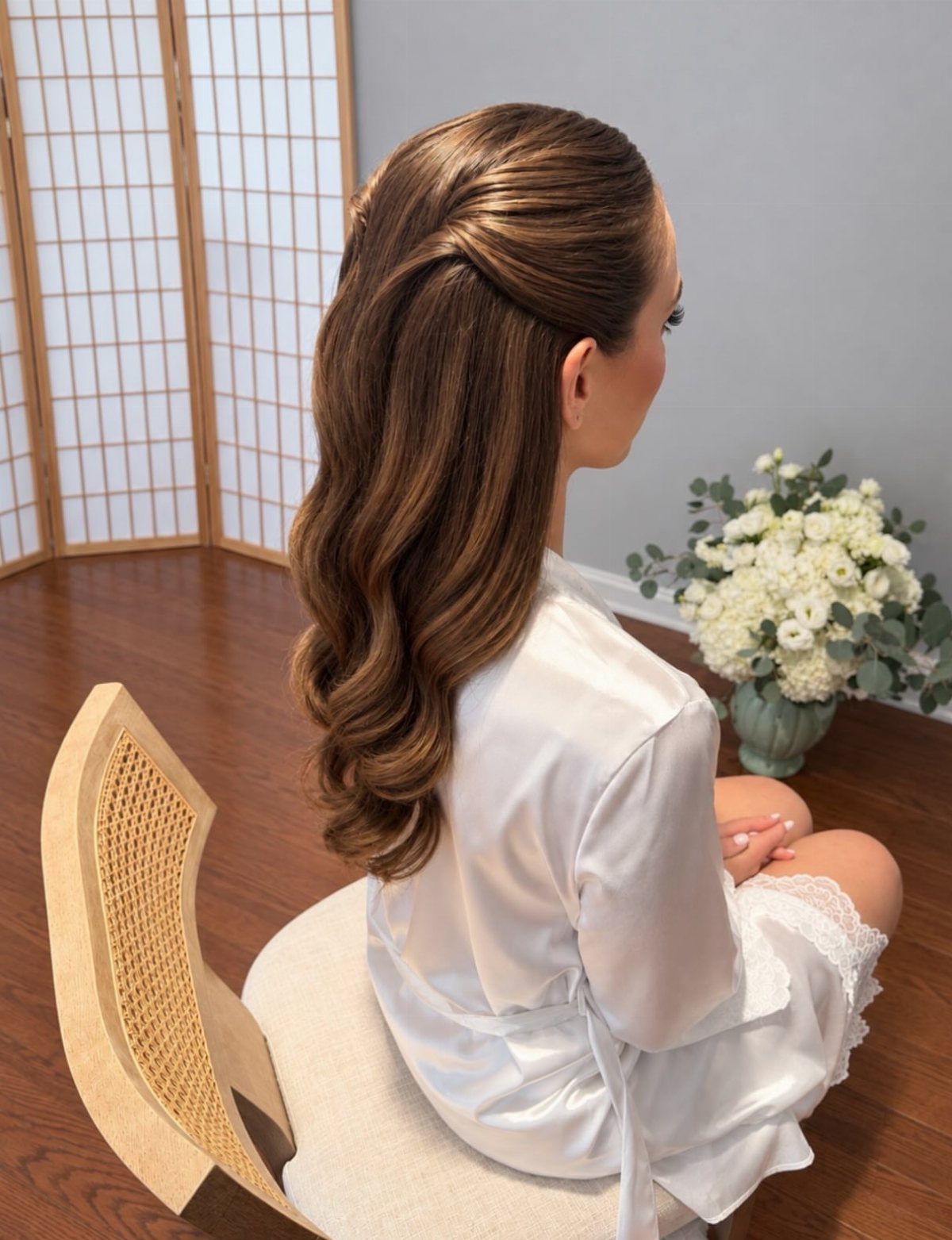 Long brown half-up hair falls in soft, gently curled waves