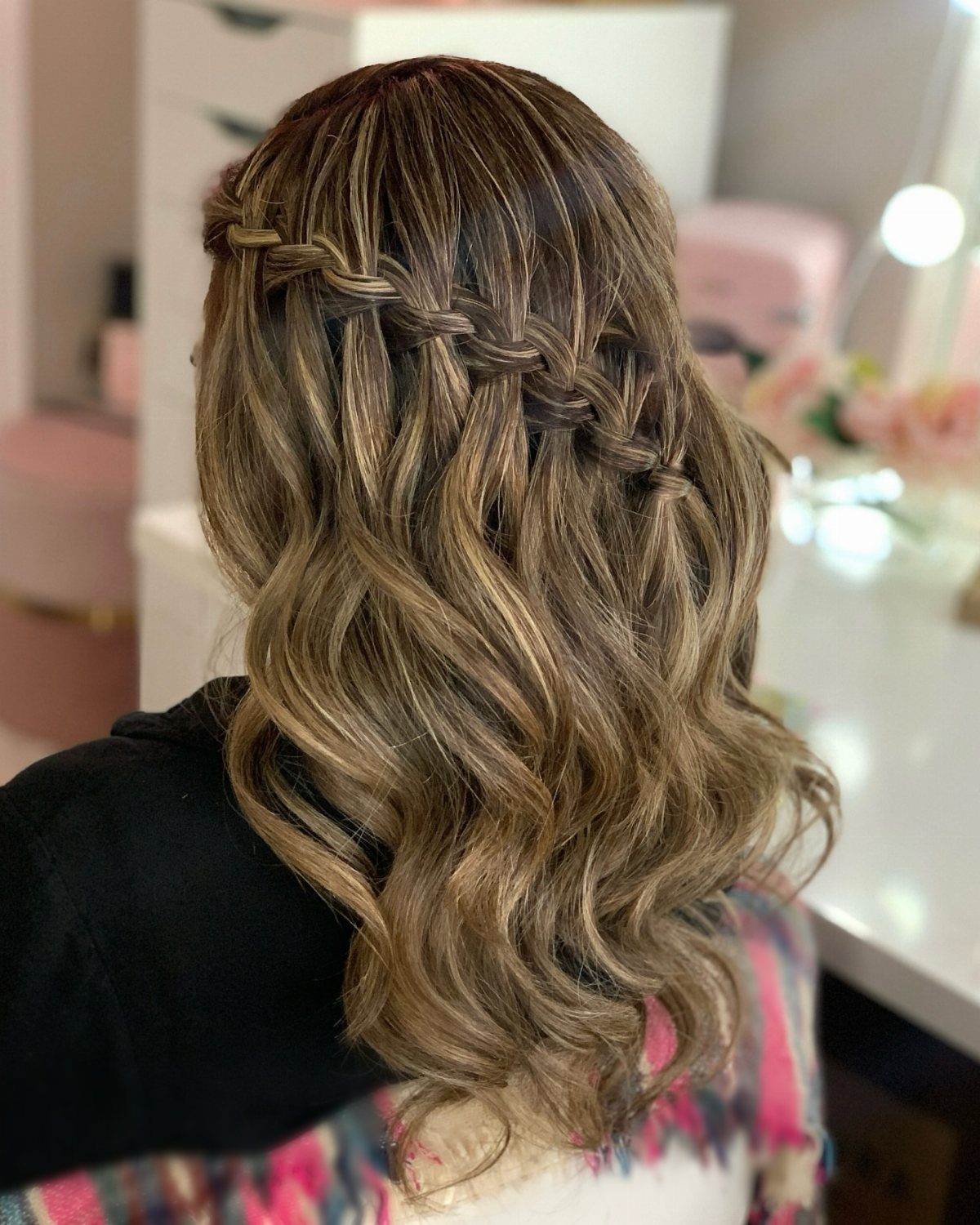 Long wavy brown hair with a joined crown braid and cascading loose strands