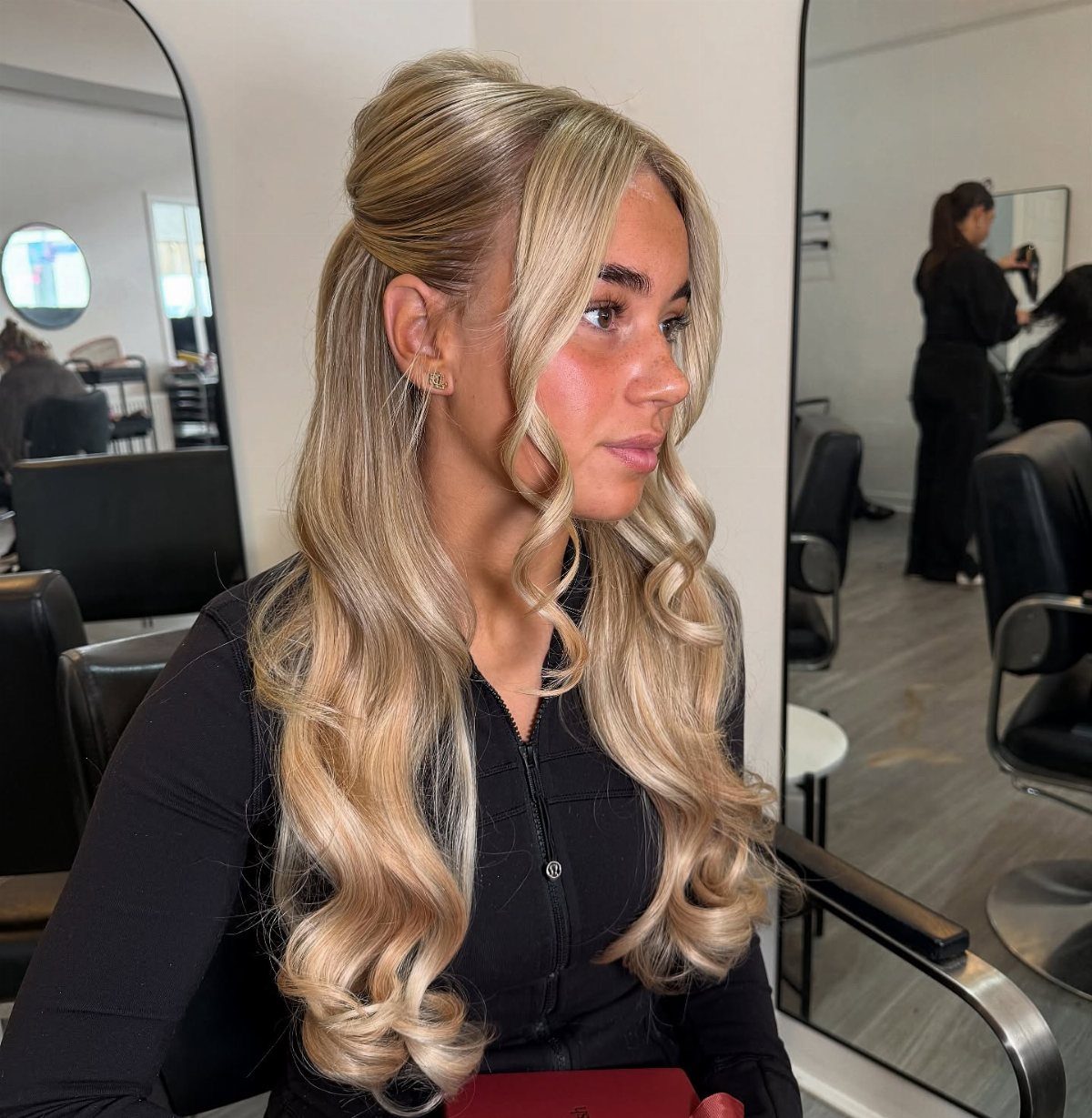 Blonde woman showing a mini bouffant half-up style with long waves