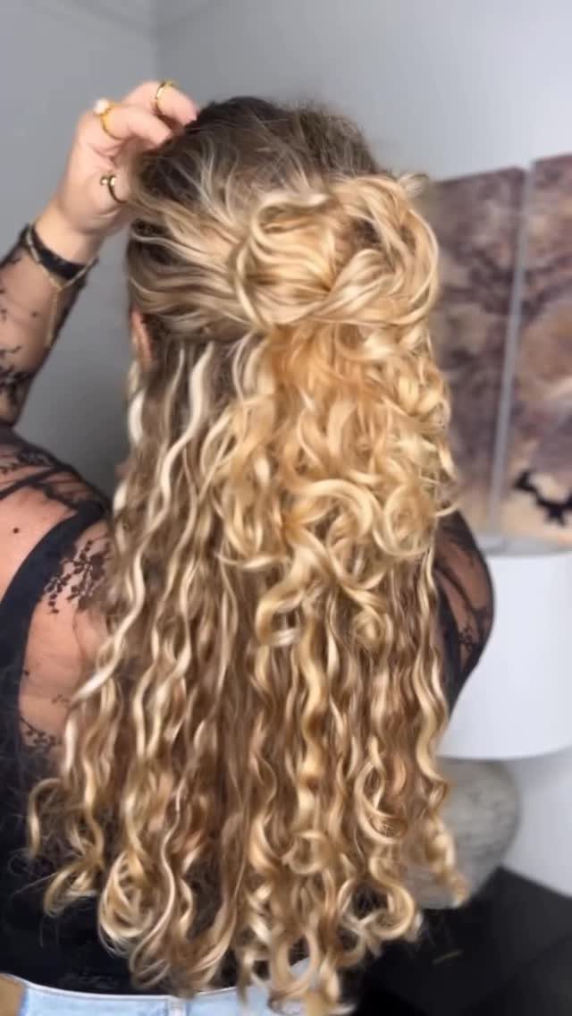 Blonde curls with a voluminous teased crown and twisted half-up sections