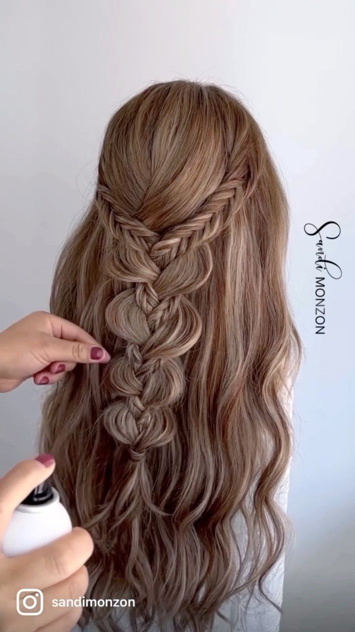 Long wavy hair with a loose, thick fishtail braid down the center